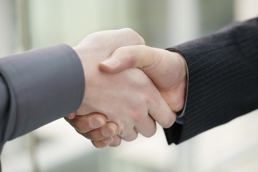 Close-up of businessmen shaking hands in an office Photograph by ONOKY - Fabrice LEROUGE
