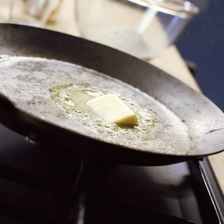 Close-up of butter melting in pan. Photograph by Jean-Blaise Hall