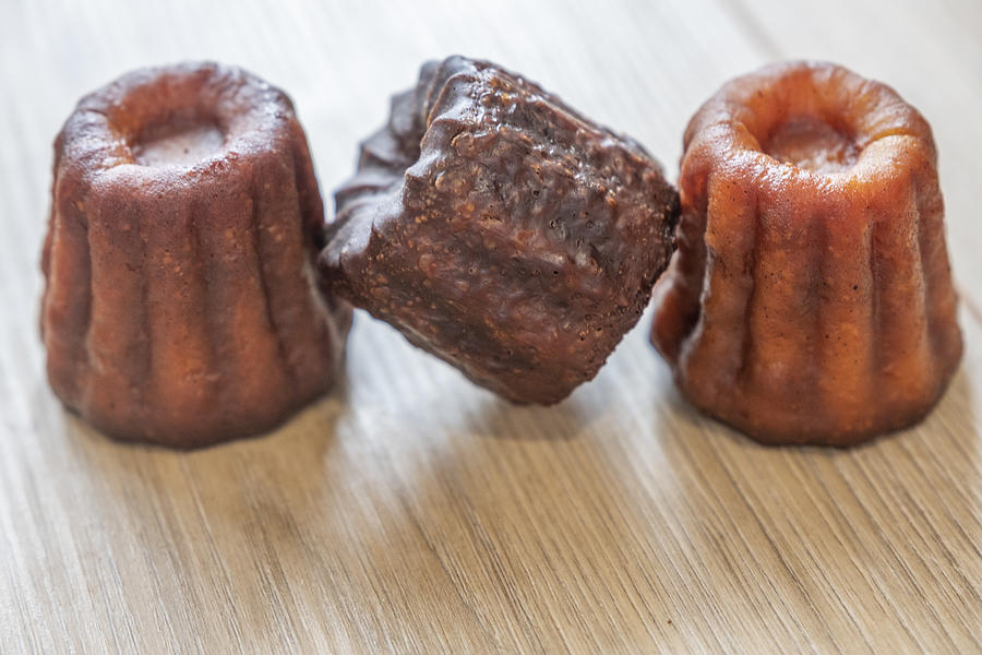 Close-up of canele cakes in a row Photograph by Ivan