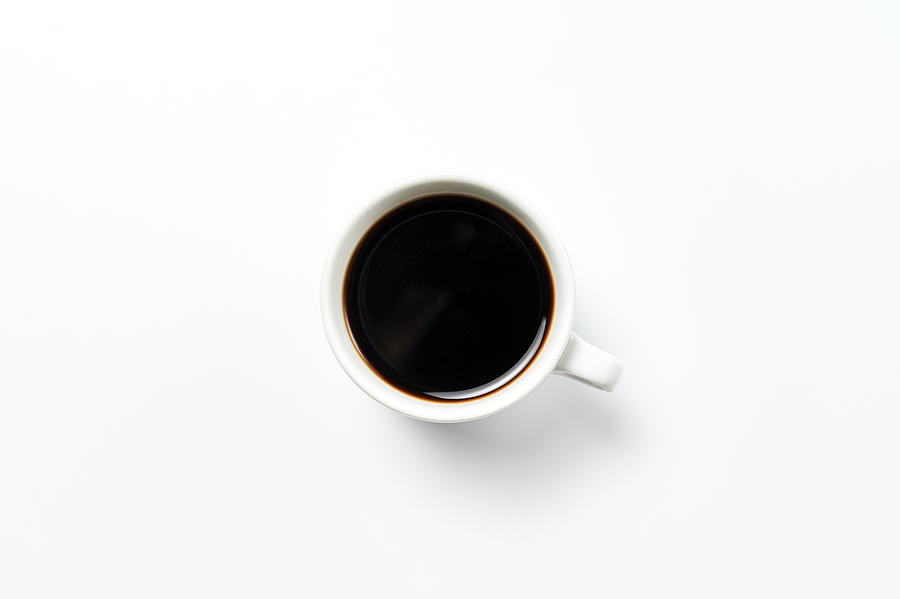 Close-up of cup of coffee on white background Photograph by F.J. Jimenez
