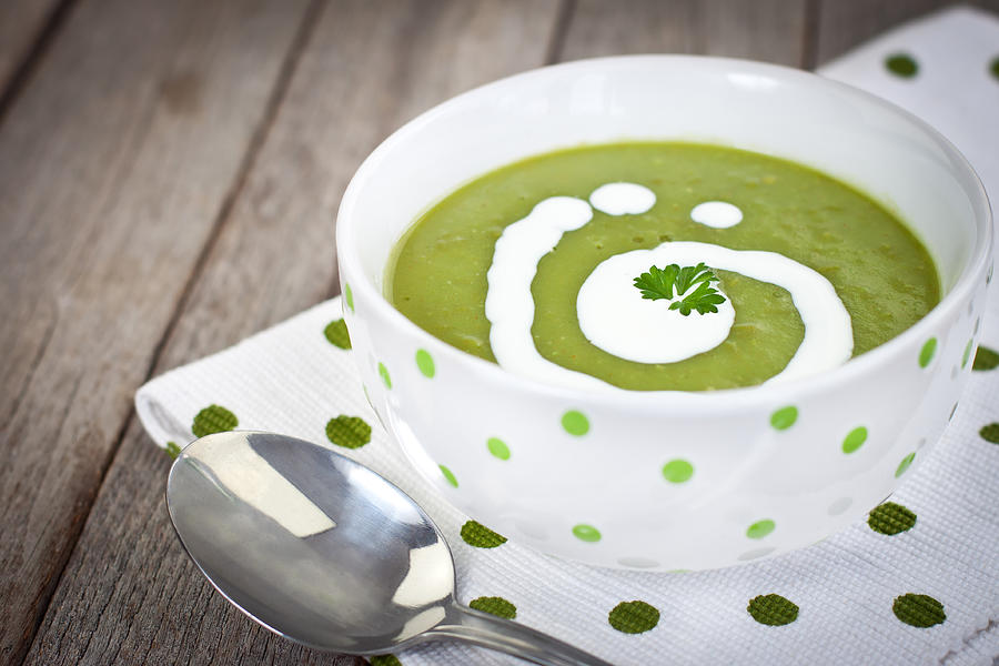 Close-up of decorated pea soup in a green dots napkin Photograph by Kajakiki
