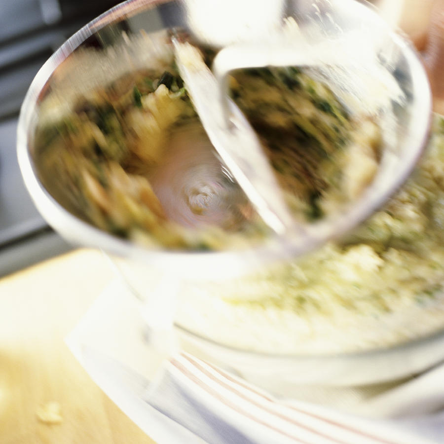 Close-up of food being mixed in bowl, blurry. Photograph by Jean-Blaise Hall