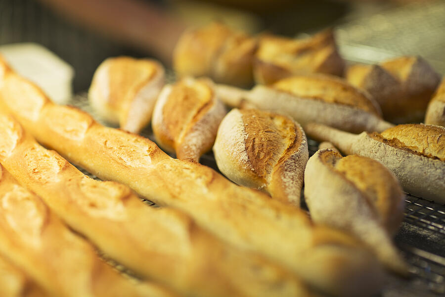 Close up of fresh bread in bakery Photograph by Sam Edwards