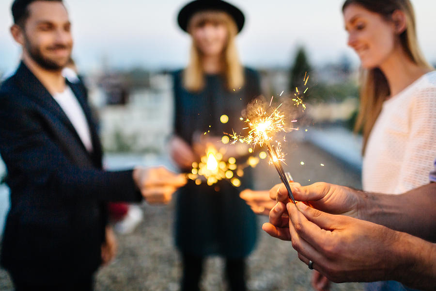 Close up of hands with sparklers Photograph by Hinterhaus Productions