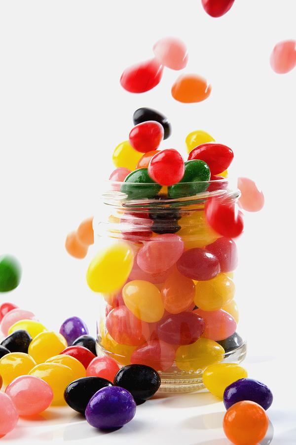 Close-up of jellybeans poured into a jar Photograph by Glowimages