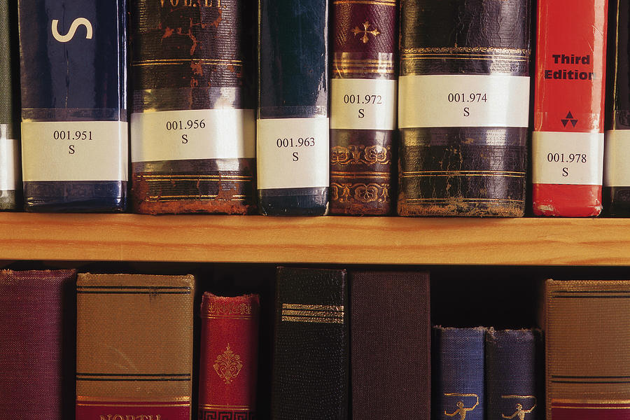Close up of library books on shelf Photograph by Comstock