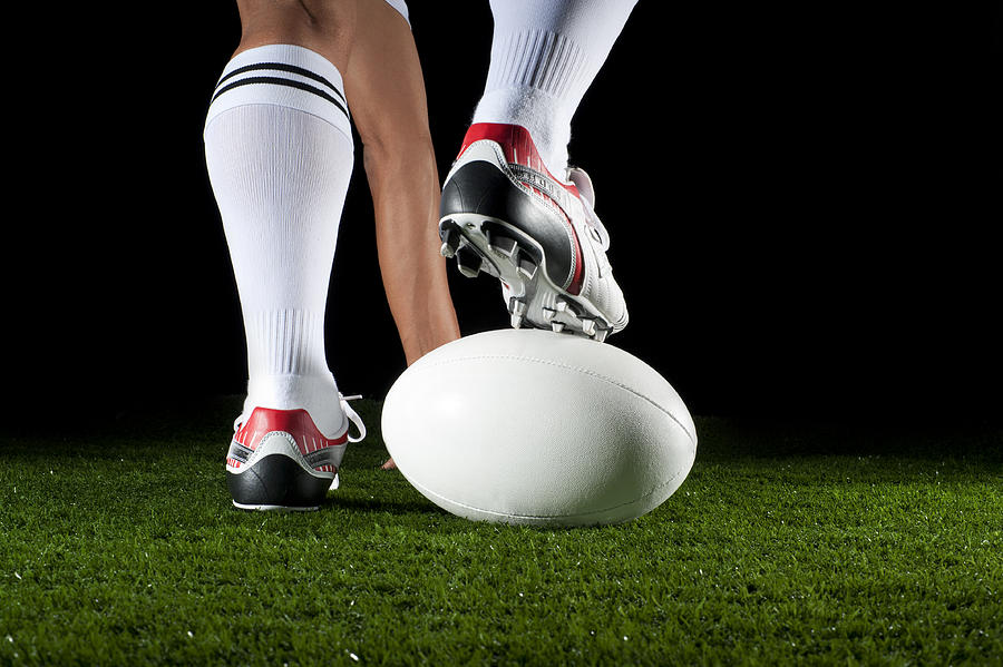 Close up of man playing a rugby ball Photograph by Courtneyk