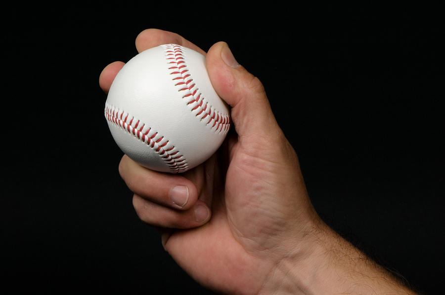 Close-up of mans hand griping a baseball Photograph by Jskiba