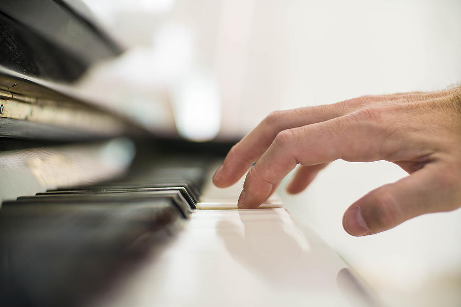 Close-up of mans hand playing the piano Photograph by Lucascapbern