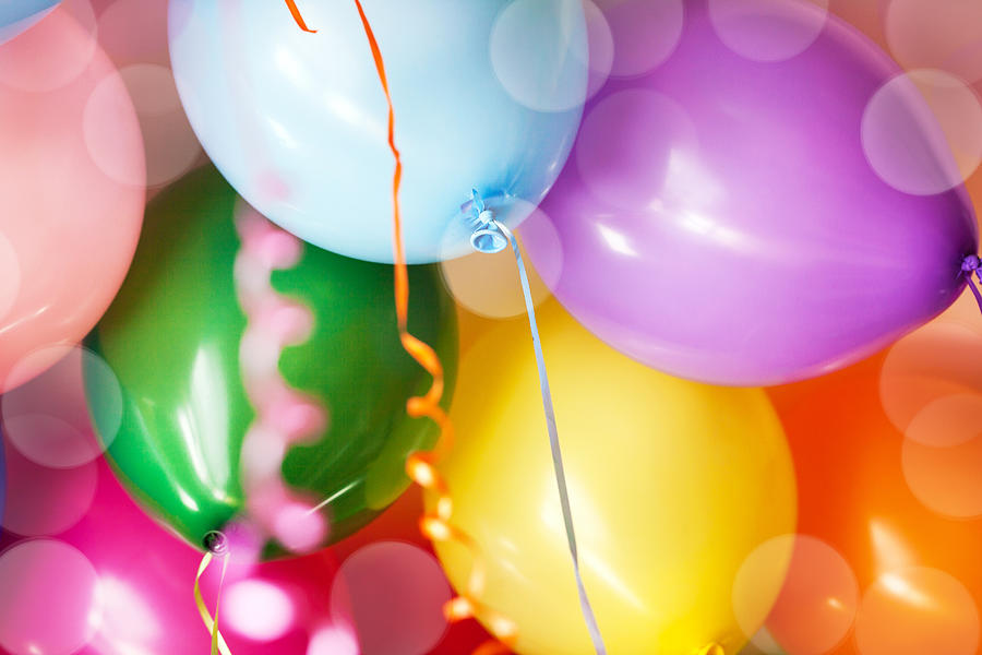 Close-up of many bright colorful funny balloons under ceiling, as background Photograph by Ekaterina Smirnova