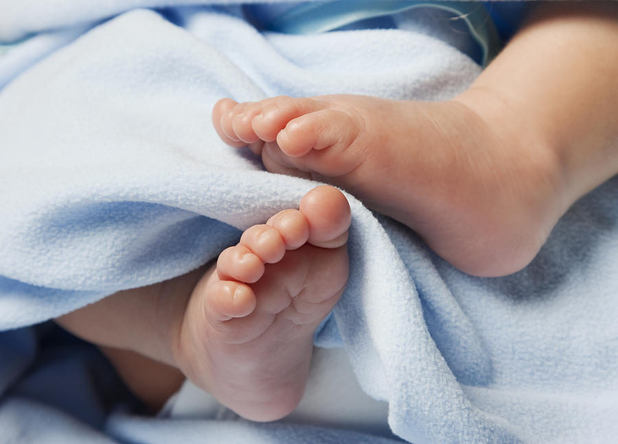 Close-up of Newborn Baby Feet with blanket Photograph by Lloret