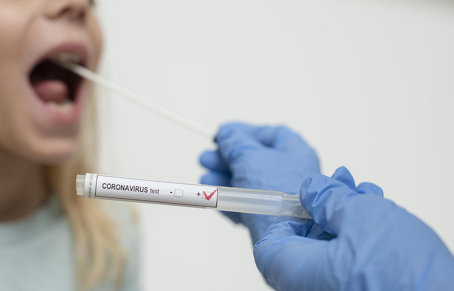 Close up of nurses hands holding buccal cotton swab and test tube ready to collect Coronarovirus test, COVID-19, 2019-nCOV analysis Photograph by Paul Biris
