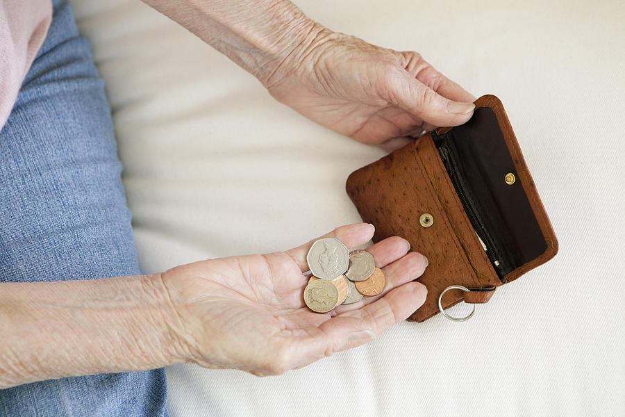 Close up of older woman counting coins Photograph by Clarissa Leahy