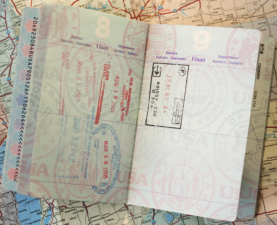 Close-up of passport on map Photograph by Jamie Grill