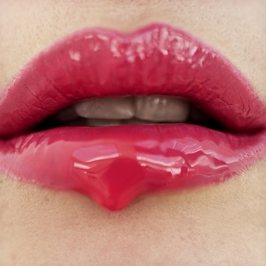 Close-up Of Pink Lipstick Dripping Off A Womans Mouth Photograph by Stockbyte