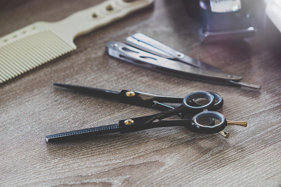 Close-up Of Scissors on wood table at barber shop Photograph by George