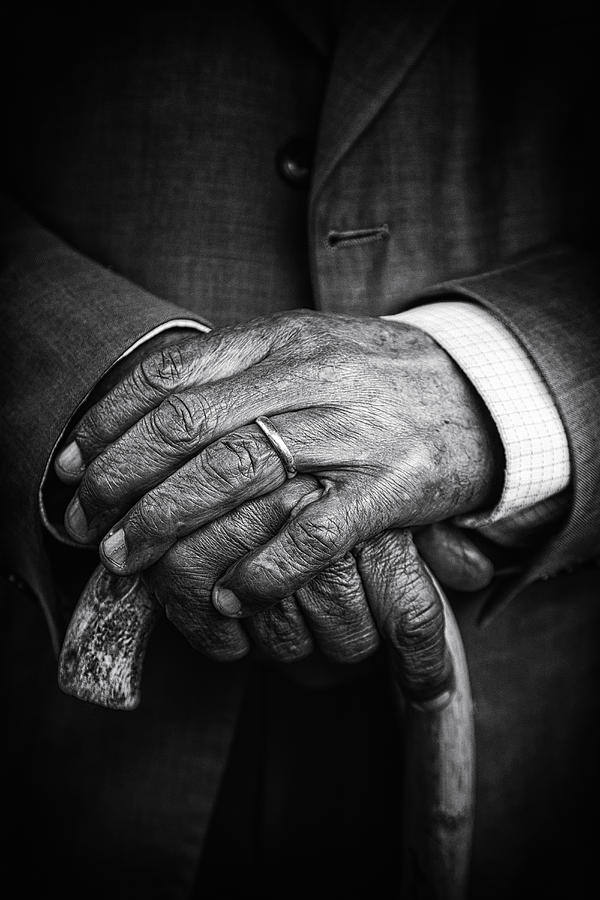Close up of senior mans hands on cane Photograph by Jeremy Woodhouse