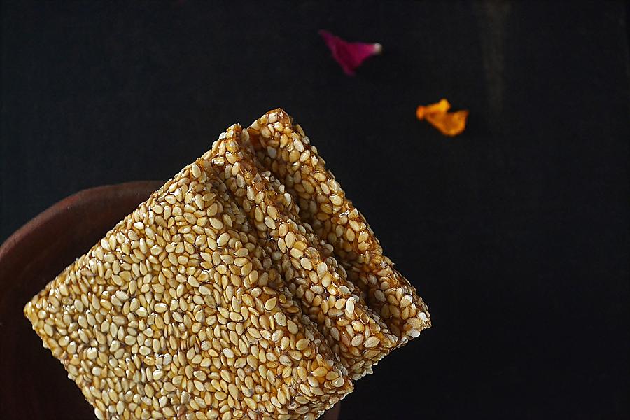 Close-up of sesame brittle/chikki in a clay bowl-Indian snack Photograph by Veena Nair