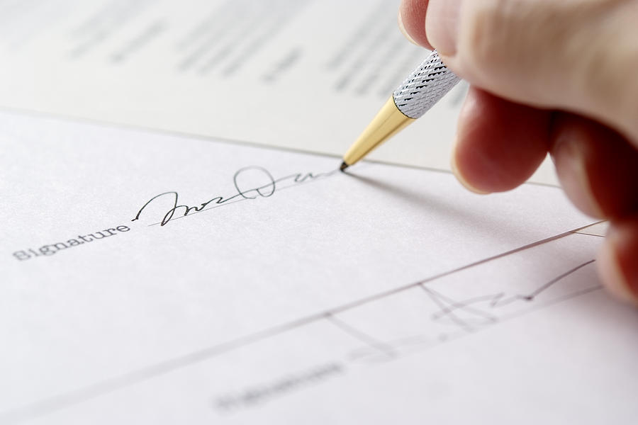 Close-up of signing a contract with shallow depth of field Photograph by Kyoshino