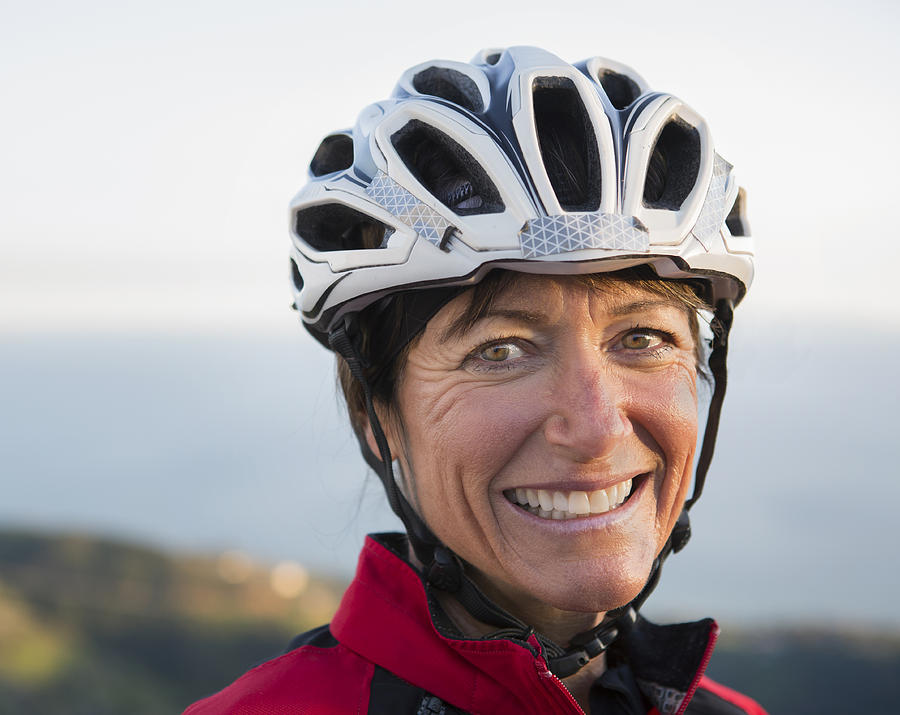 Close up of smiling Caucasian woman wearing helmet Photograph by Sam Diephuis