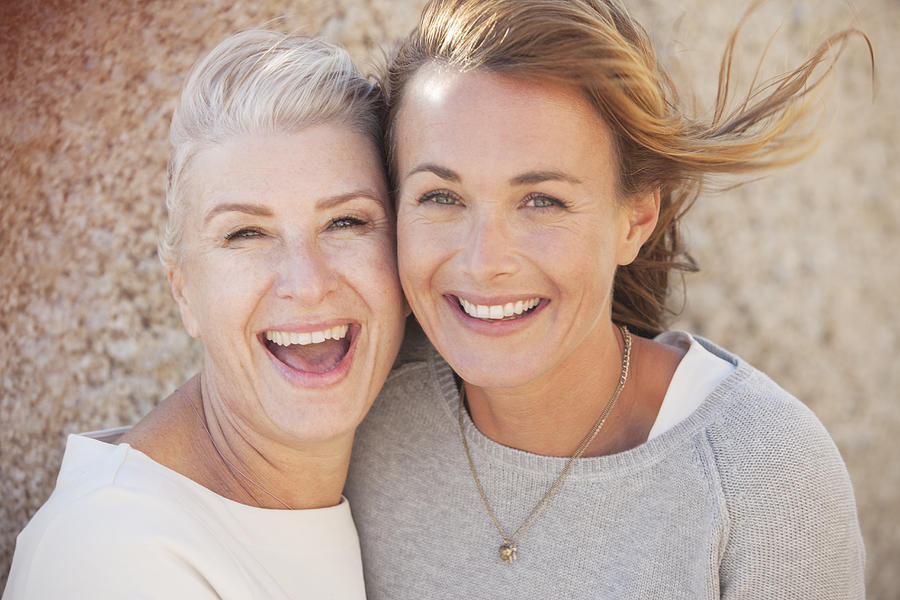Close up of smiling mother and daughter outdoors Photograph by David Lees