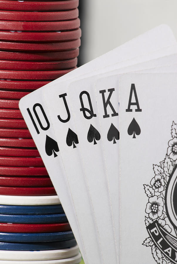 Close-up of the poker of spades with a stack of gambling chips Photograph by Glowimages Close-up of the poker of spades with a stack of gambling chips Photograph by Glowimages