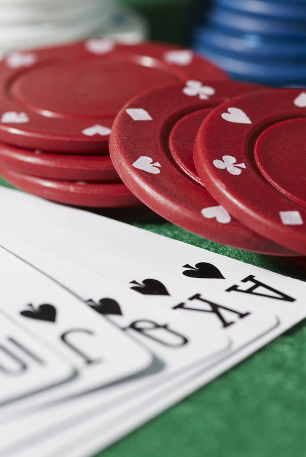 Close-up of the poker of spades with gambling chips on a gambling table Photograph by Glowimages