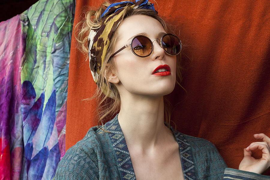 Close-up of thoughtful stylish woman wearing sunglasses against fabric Photograph by Yulia-Images