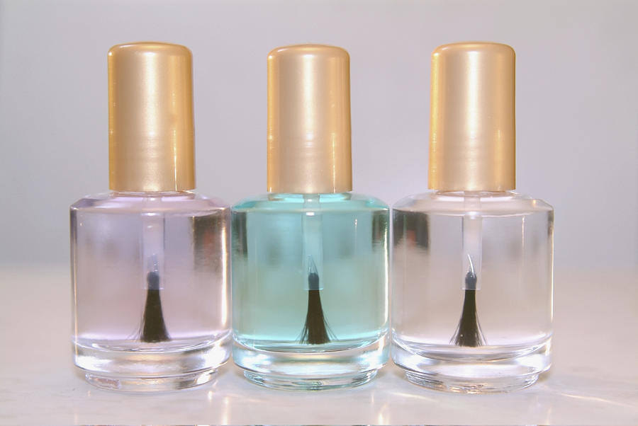 Close-up of three bottles of clear nail polish Photograph by Medioimages/Photodisc