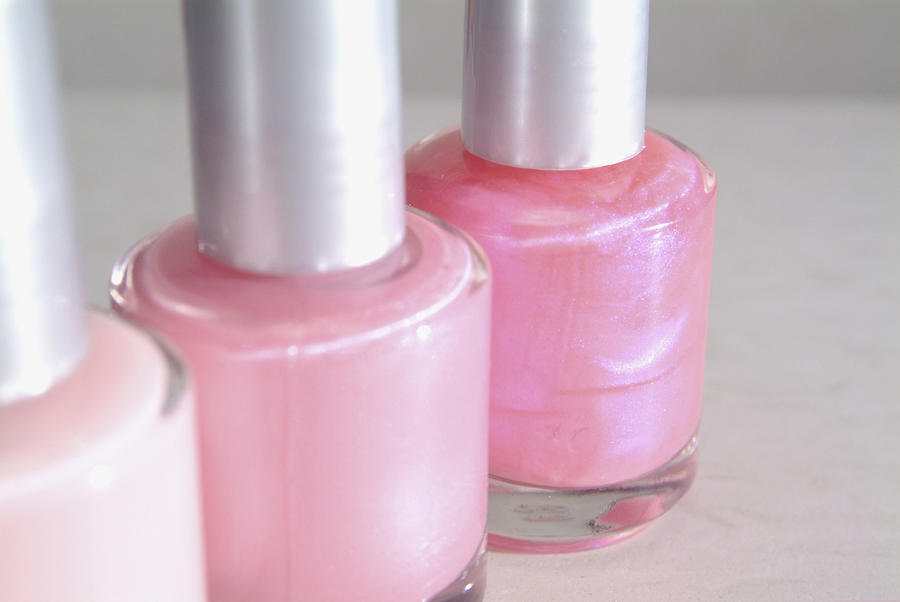 Close-up of three bottles of pink nail polish Photograph by Medioimages/Photodisc