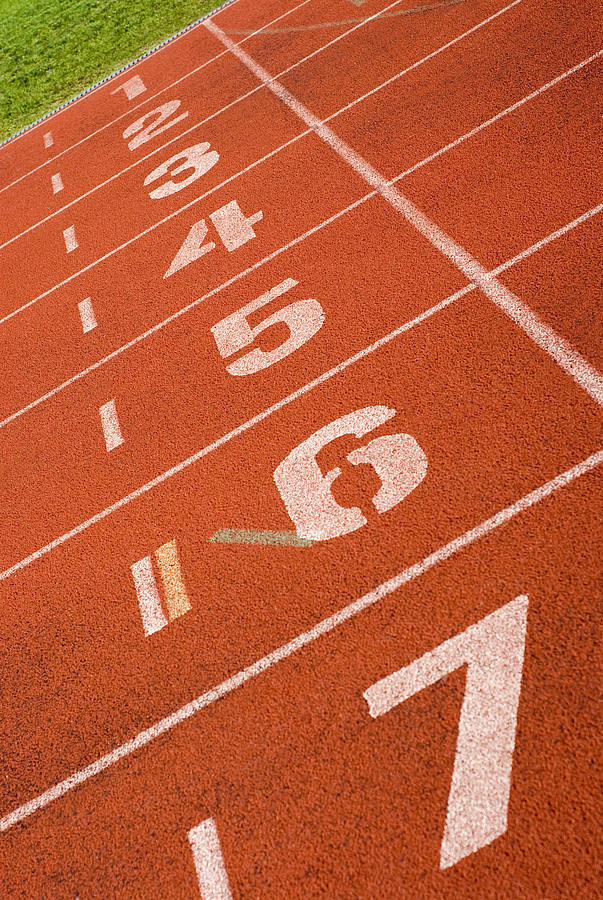 Close-up of track numbers on a running track Photograph by Glowimages