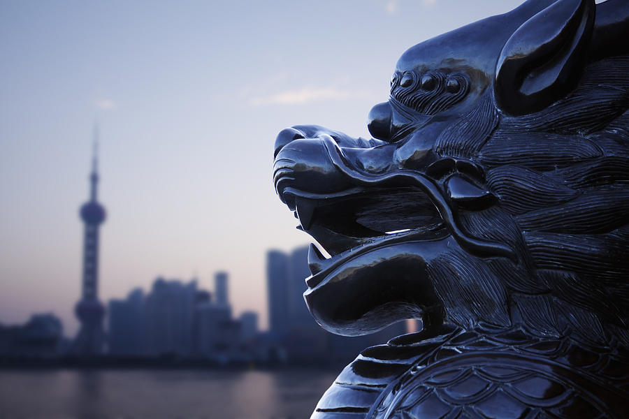 Close-up of traditional Chinese statue with Shanghai skyline in the background Photograph by XiXinXing