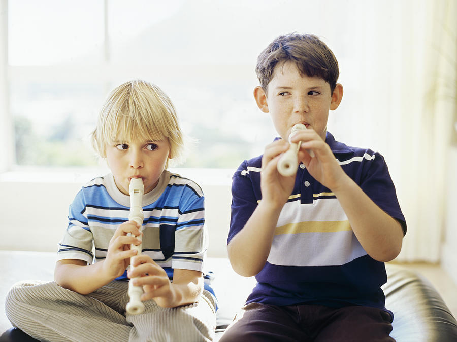 Close-up of two boys playing the recorder Photograph by George Doyle