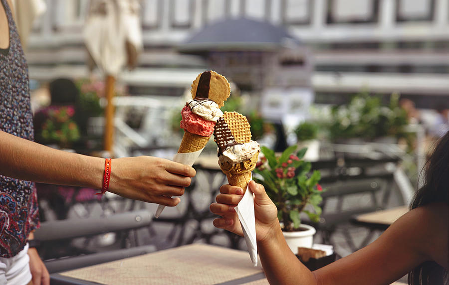 Close-up of two hands holding delicious ice creams that come together as a toast Photograph by Sol de Zuasnabar Brebbia