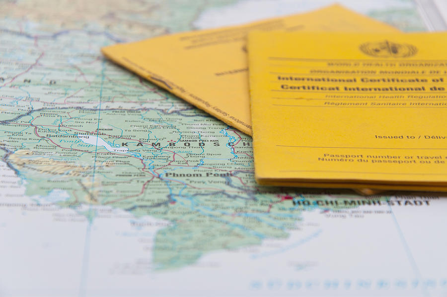 Close Up of Vaccination Certificate and world map. Photograph by Nodramallama
