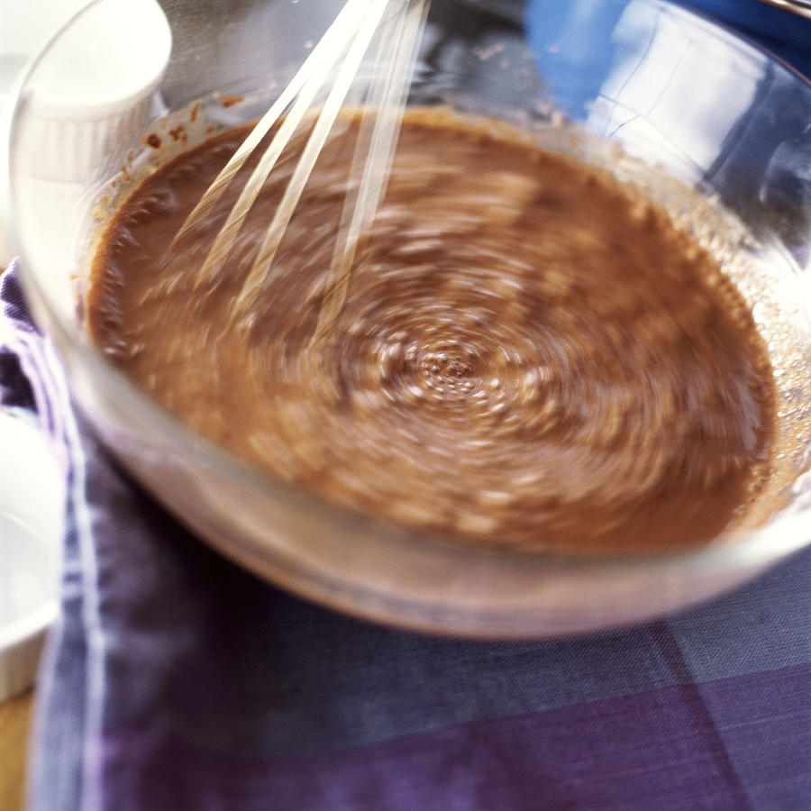 Close-up of whisk mixing food in bowl. Photograph by Jean-Blaise Hall
