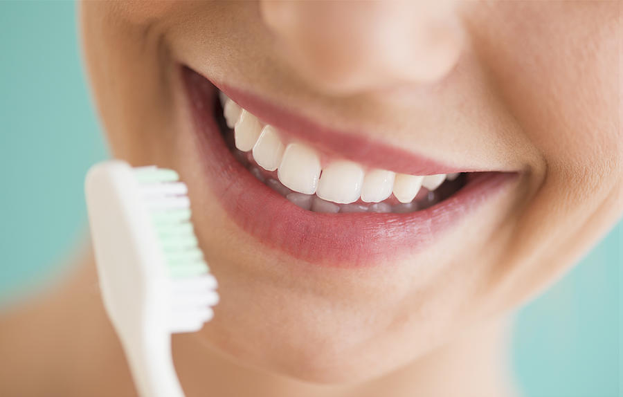 Close-up of woman brushing teeth Photograph by Tetra Images