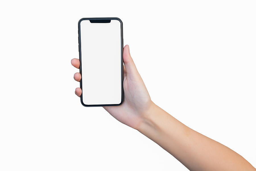 Close up of woman hand holding smartphone on white background, cropped hand using smartphone on the background white Photograph by Puttapon