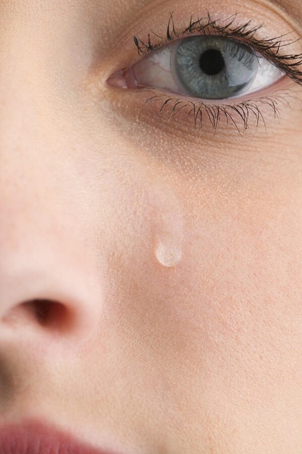 Close-up of womans face with tear Photograph by Jupiterimages
