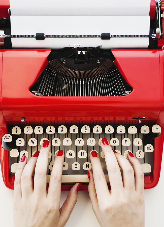 Close up of womans hands with red nail polish typing on antique typewriter Photograph by Tetra Images