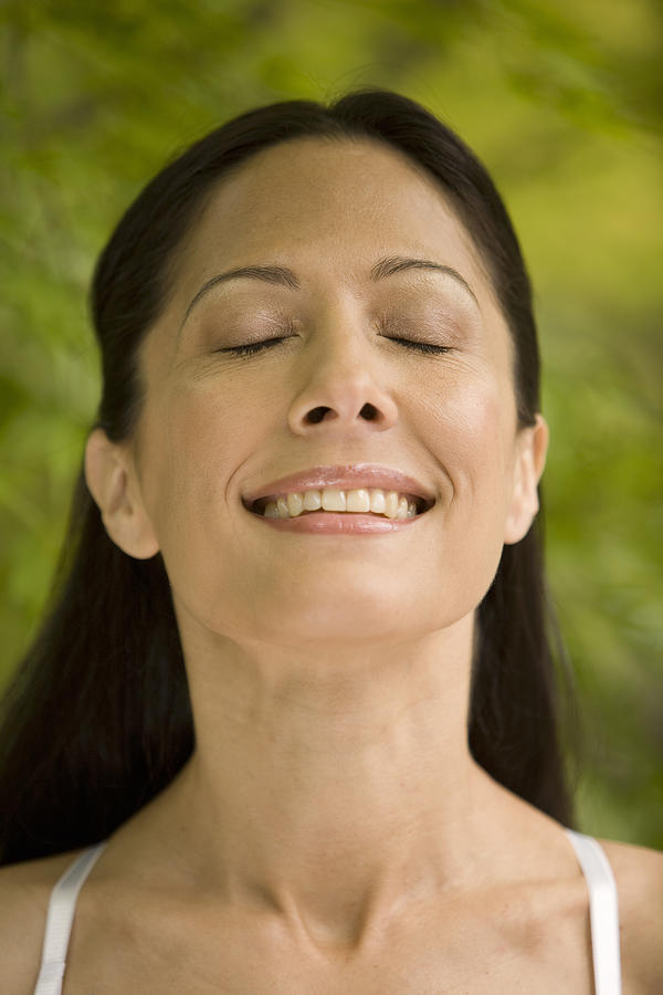 Close-up of young woman outdoors, eyes closed Photograph by John Giustina