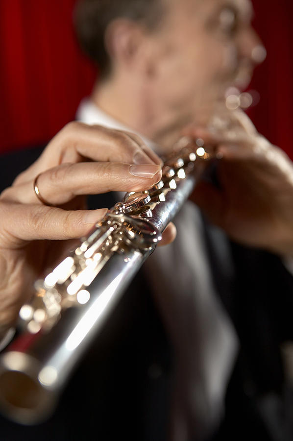 Close-Up on the Hand of a Male Flautist Photograph by Digital Vision.