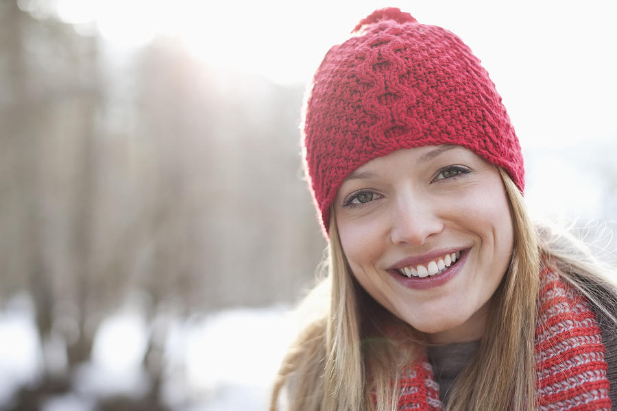 Close up portrait of smiling woman wearing red knit hat Photograph by Tom Merton