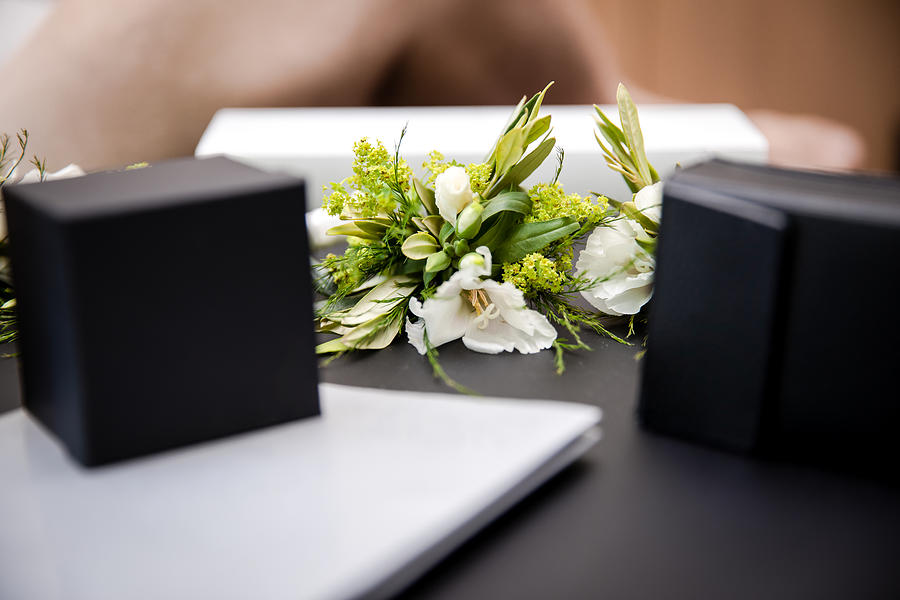 Close-Up Shot of Boutonnières and Jewelry Boxes on a Table during Wedding Celebrations in Berlin, Germany Summertime Photograph by Morten Falch Sortland