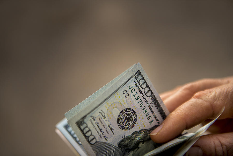 Close-up shot of unrecognizable person holding USA Dollar bills Photograph by CiydemImages