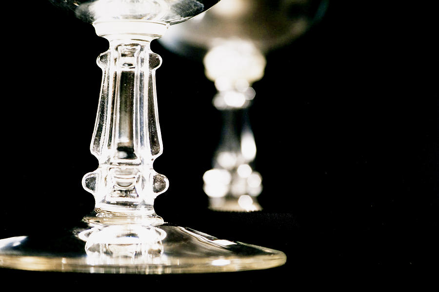 Close up view of crystal stemware glasses on black. Photograph by Fstop123
