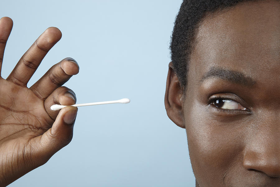 Close Up Young Man Holding Cotton Bud Photograph by Emma Innocenti