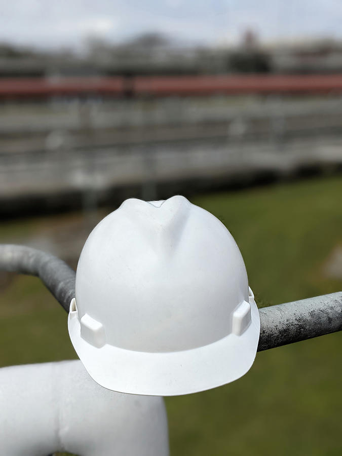 Closeup Of A Hard Hat At Industrial Plant Photograph by Alex Grichenko