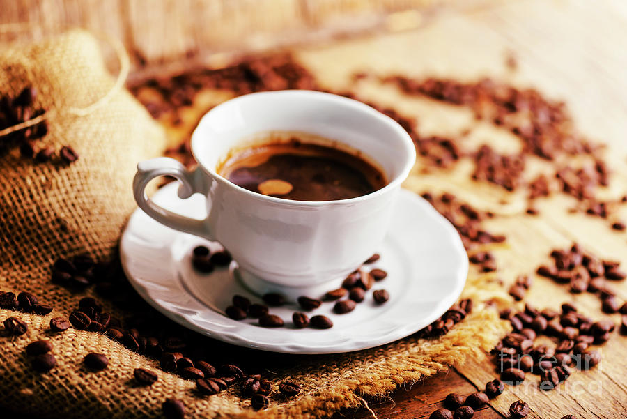 Closeup of coffee cup and coffee beans with vintage burlap on ru Photograph by Jelena Jovanovic