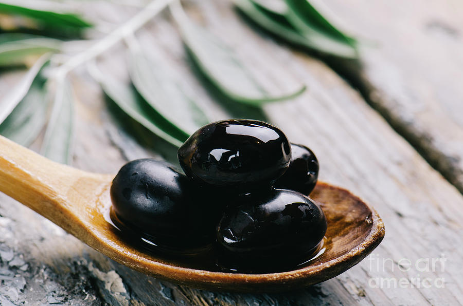 Closeup Of Fresh Black Olive In Oil On Rustic Wood Table. Organi Photograph